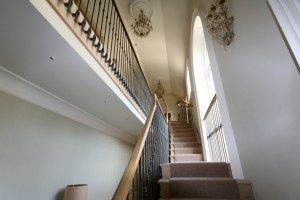 Classic staircase with wrought iron balusters - White Oak | Cut String | Wrought Iron Balusters | Carpet
