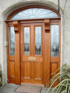 Front entrance door and screen with arched fanlight - Iroko Door and Screen | Hand Carved Columns | Leaded Glass | Brass Hardware