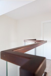 Walnut handrail with square profile and glass balustrade