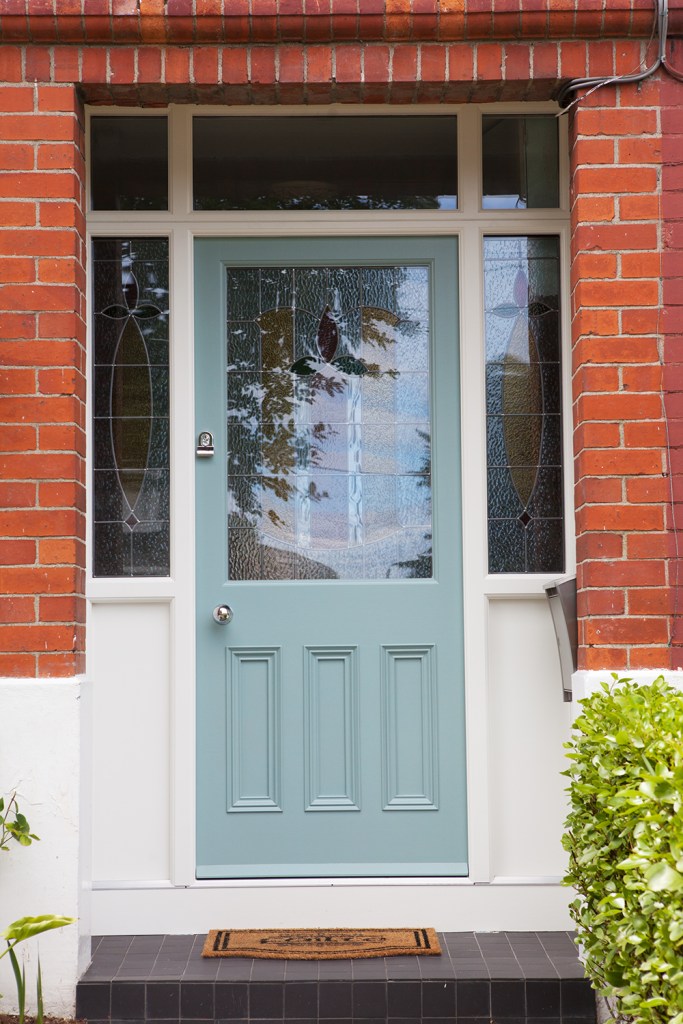 Mint green door with white frame - fanlight window - sidelite windows - red brick casing