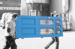 Two men carrying blue door with transom stained glass windows