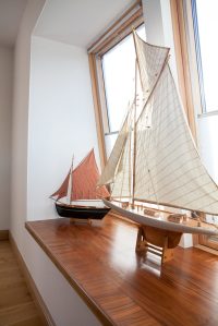 wooden window seat with model boats