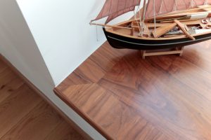 Model boat on wooden window seating