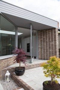 Pivot door and splayed window - Iroko Pivot Door | Double Glazed Glass | RAL 7004 Grey | Satin Chrome Hardware | Pivots on Concealed Pivot Hinge | Splayed Screen | Three Point Locking System