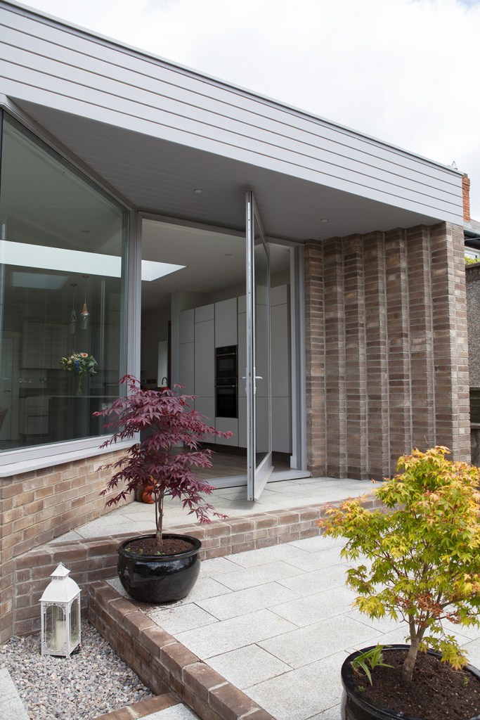 Pivot door and splayed window - Iroko Pivot Door | Double Glazed Glass | RAL 7004 Grey | Satin Chrome Hardware | Pivots on Concealed Pivot Hinge | Splayed Screen | Three Point Locking System