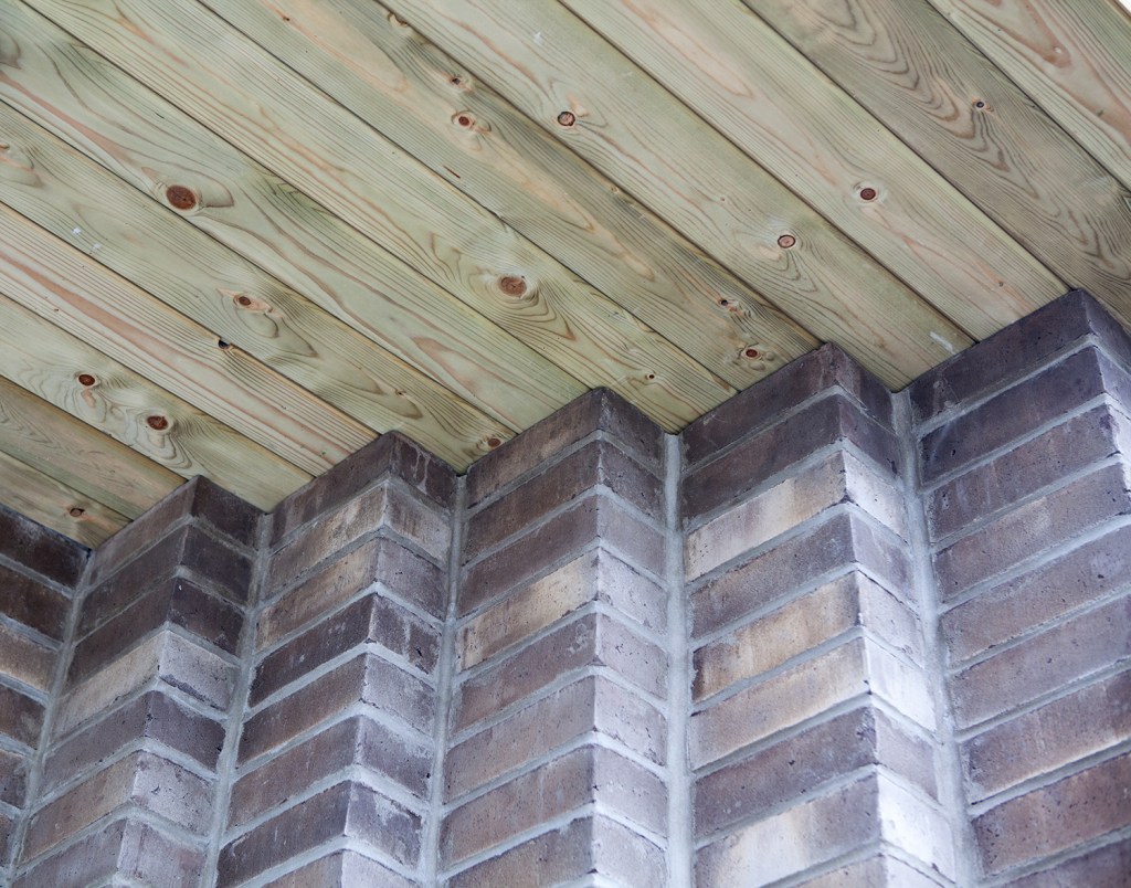 Brick staircase - sheeted wood wall