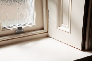 Stainless steel hardware on sliding sash window with shutters - white window frame and casing with interior window sill