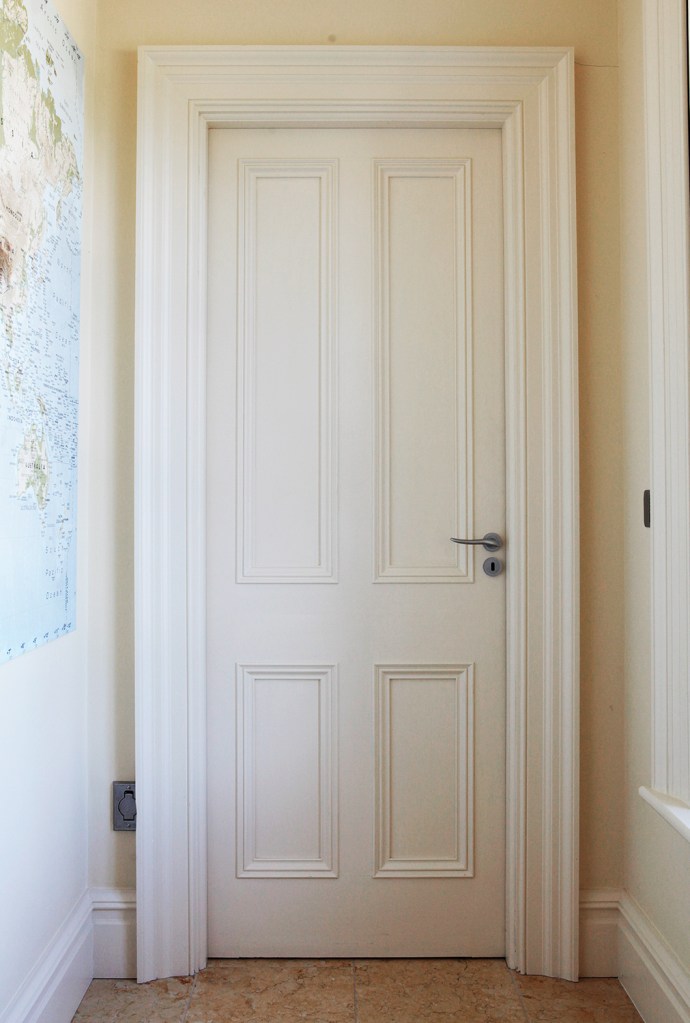 white panel door with white door frame and casing