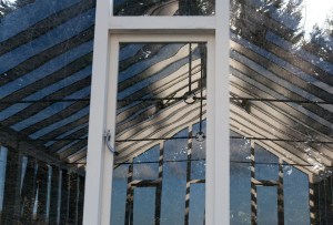 Glass house with wall windows and ceiling windows - silver handle - window with white frame