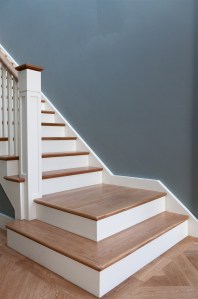 Staircase landing with decorative oversized newel post - staircase landing - wooden tread