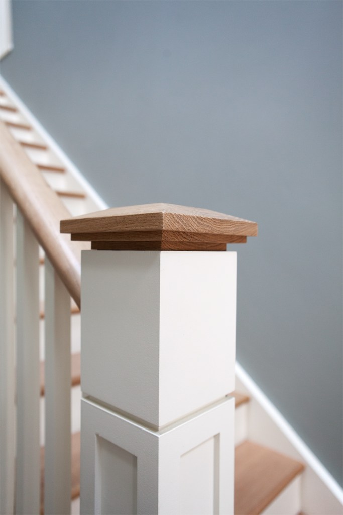 Oversized square poplar newel post with white oak cap