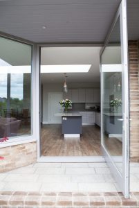 Open pivot glass door with silver frame