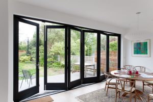 Black frame glass bi-fold door in dining room