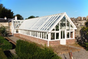 Window roof and walls - brick half wall - gravel pathway - white glass transom door
