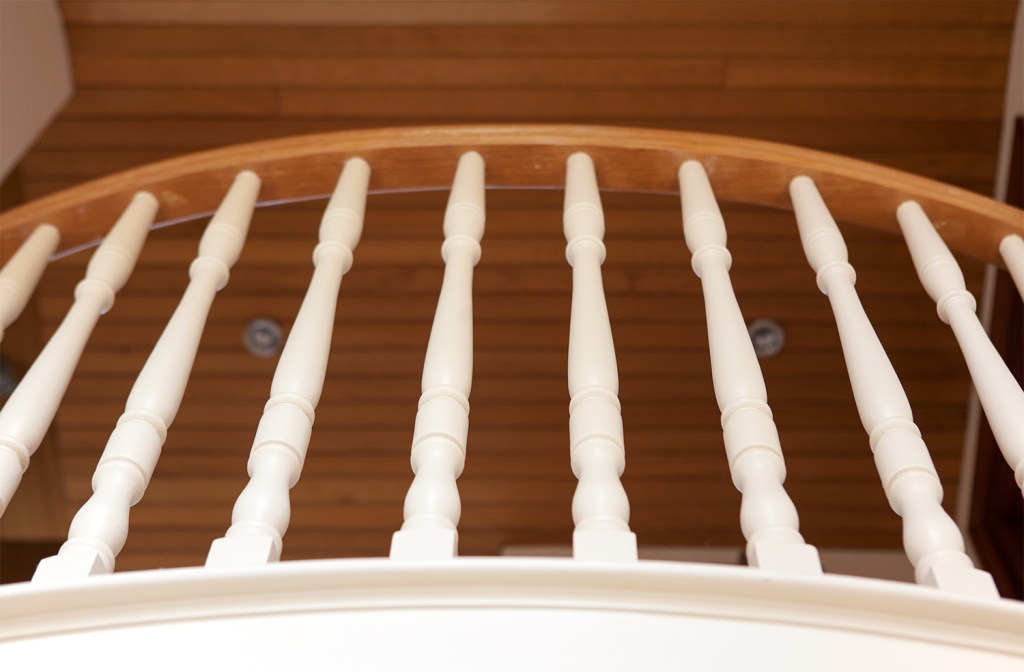 White wood baluster - sheeted wood ceiling