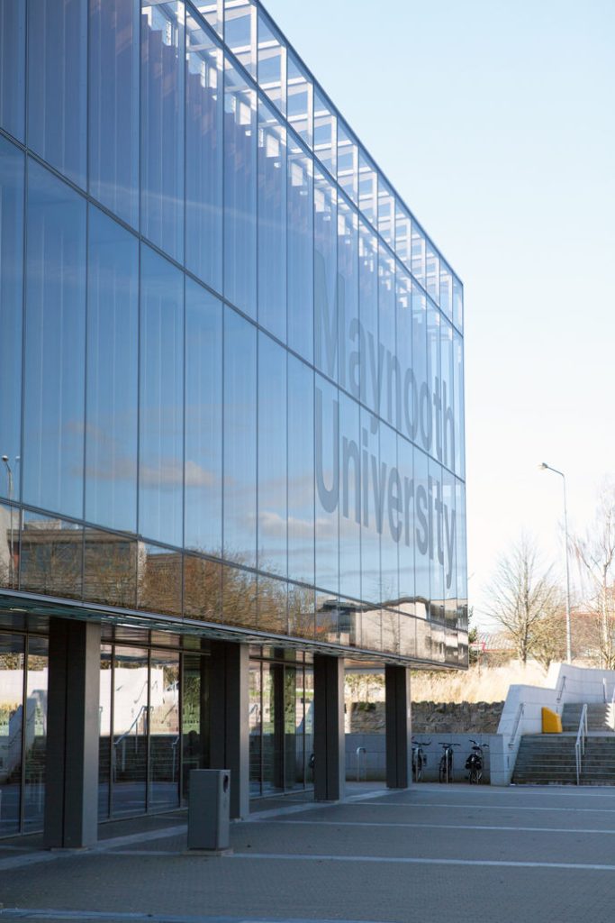 Glass window wall of university of Maynooth - parking lot view
