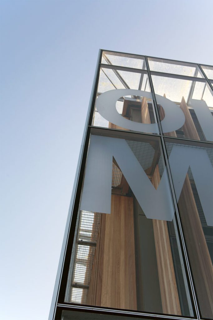 Sandblasted letters on wall window corner view