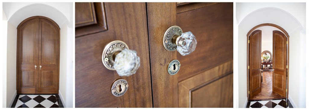 Wooden arch double door - crystal and bronze door knob detail - checkered black and white tiled floor