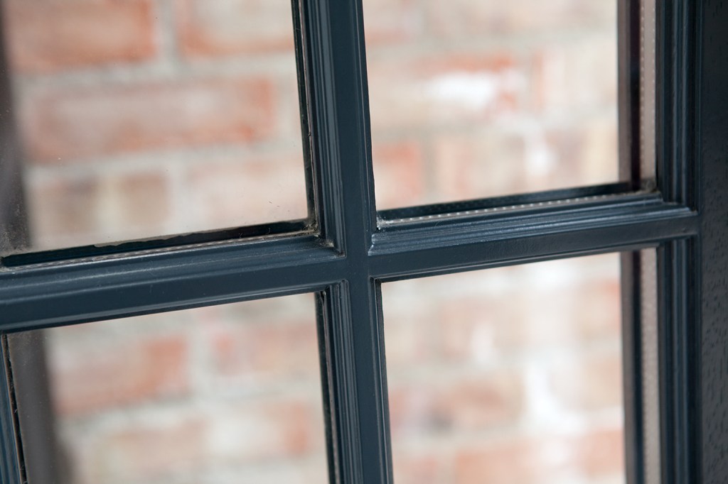 window with black window frame and grille