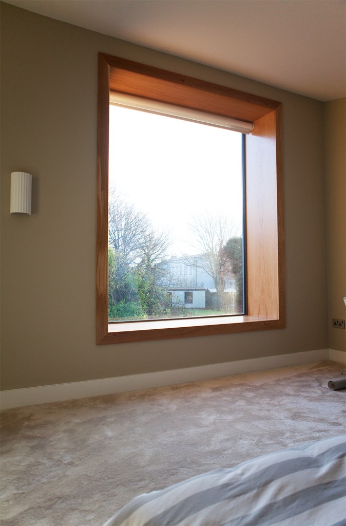 big clear window with wooden frame and casing creating a interior window sill