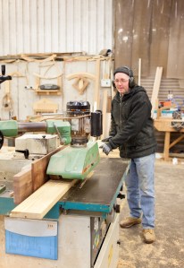 Worker in action - cutting wood - machinery