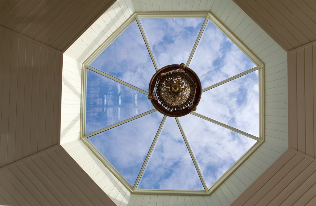 Blue sky - skylight window - window in ceiling - light hanging - white sheeted ceiling