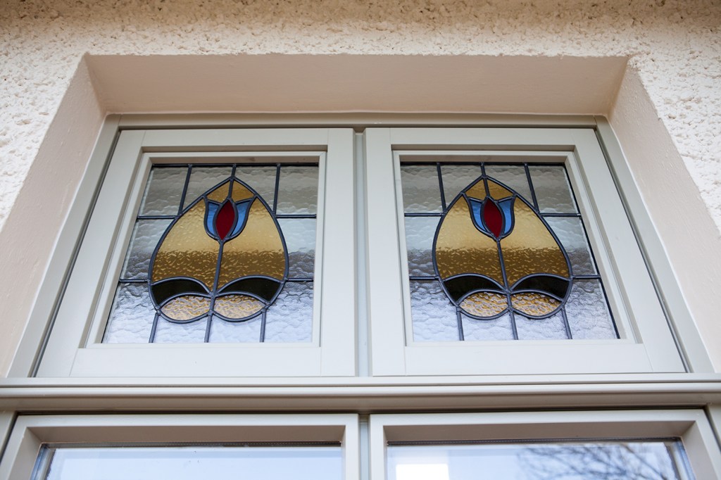 Stained glass with tulip shape and decor - blue, red, yellow and black stained glass