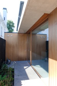 Window wall - sheeted wood wall - patio - extended roof - garden patch