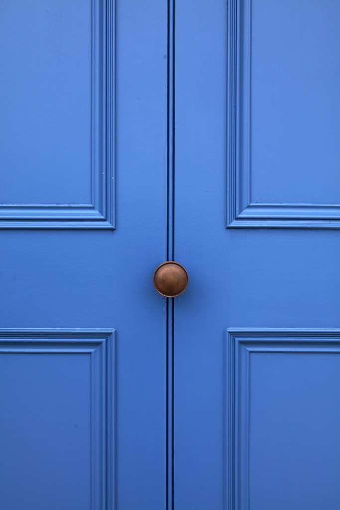 Blue door with bronze door knob