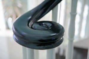 Right hand turnout - stair newel - carved stair cap - dark wood handrail