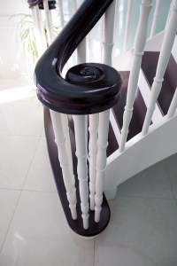 Dark wood swirl staircase newel post - dark wood nosing - white staircase baluster - dark wood handrail