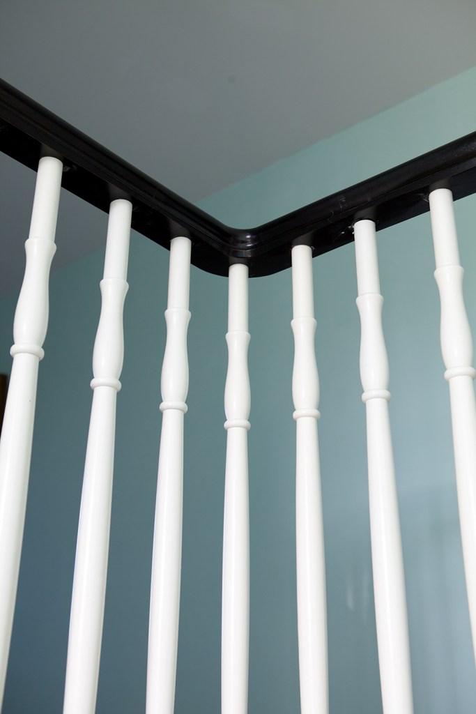 White wood staircase baluster and dark wood handrail