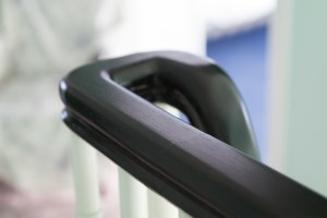 Close up photo of staircase handrail - dark wood handrail