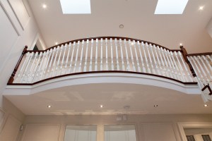 Inside balcony with white baluster and dark wood handrail - white ceiling