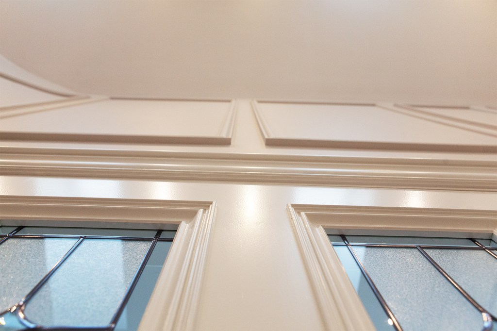 Looking up at ceiling panel - stained glass frame - white door frame