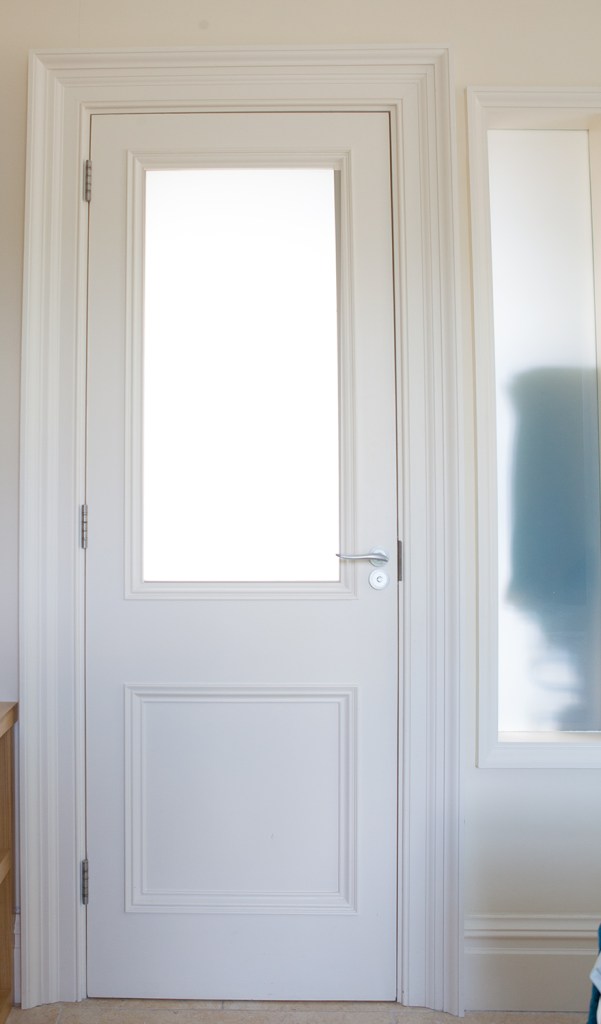 White glass panel door with white door frame and panel - silver door handle - sidelite door window