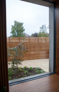 Wooden interior window sill - window with black frame - backyard view