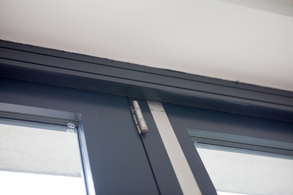 Silver door hinge - black door frame and top skirting
