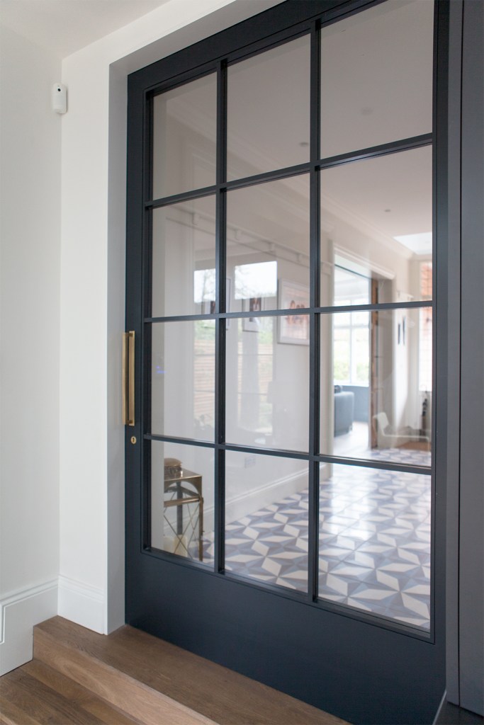 Big sliding transom door - dark door frame and grille - closed sliding door - wooden step