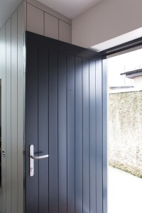 Single black wood door with silver door handle - solid single door - open door