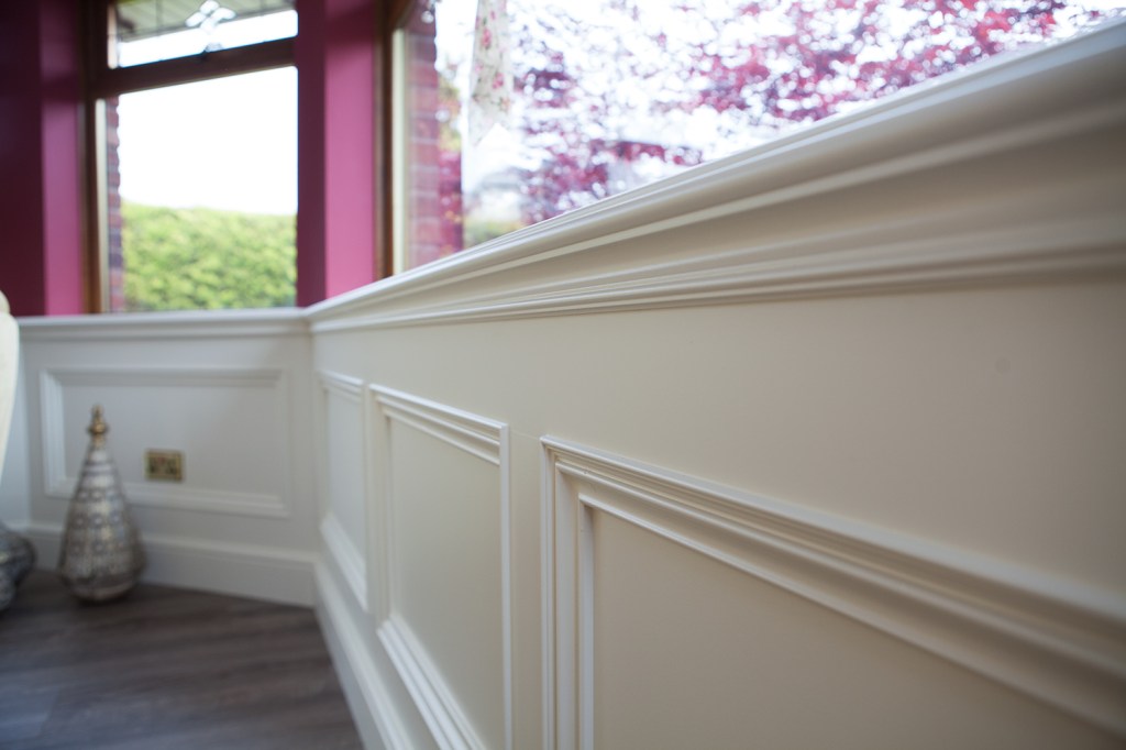 White interior window sill with white wood carving and frames