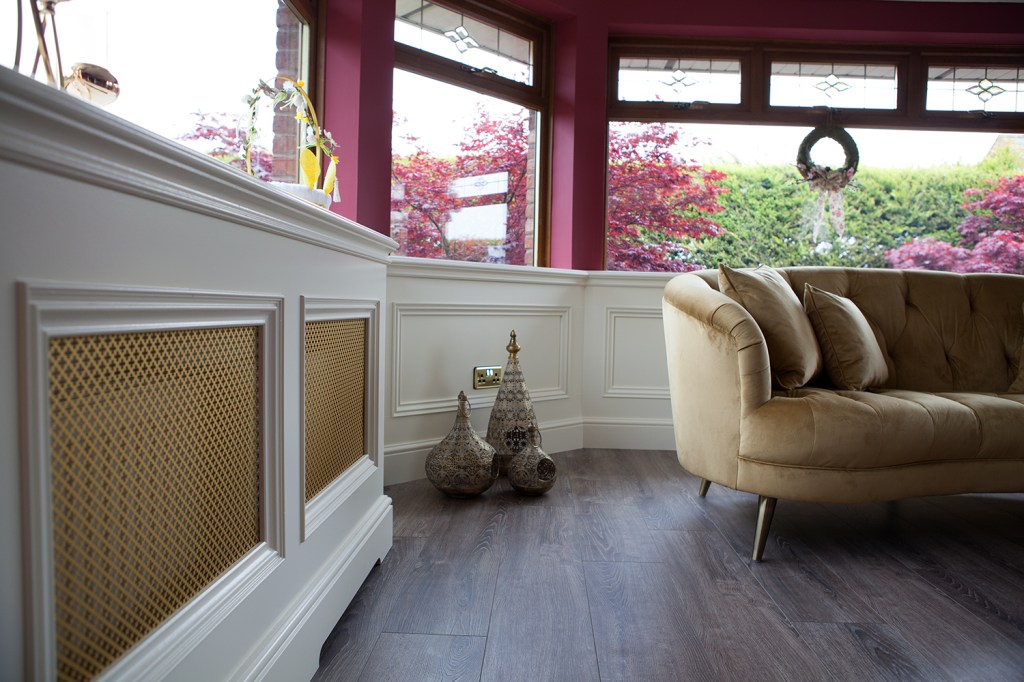Natural light entering the lounge area - white and bronze radiator cover with white frame - floor decor - laminated floor - lounge area - wall windows
