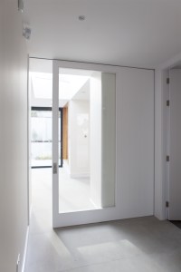 White transom pocket sliding door with a white frame - half window - white ceiling and walls