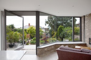 window walls - natural light - pivot glass door - brick window bench - garden view - lounge area