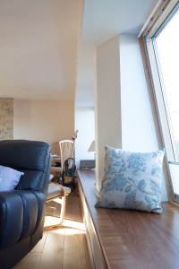 Inside interior wooden window sill with decorative pillow next to window
