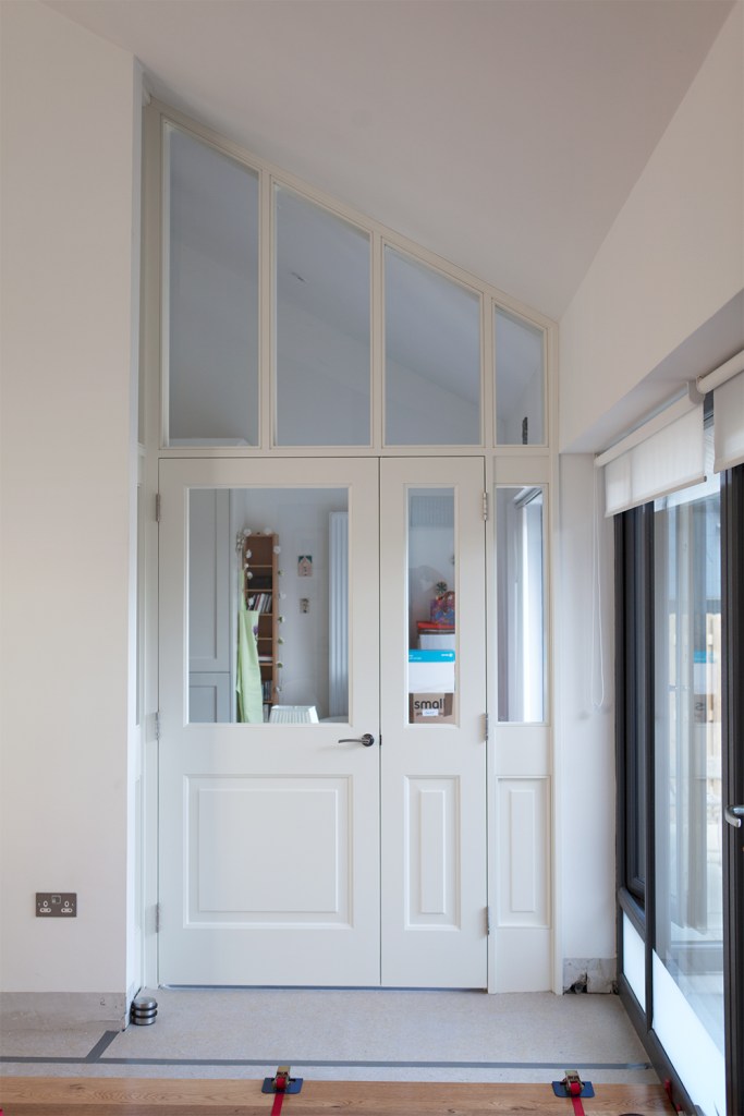 Transom window - windows above door - transom door - white window and door frame - fanlights -white ceiling - white walls