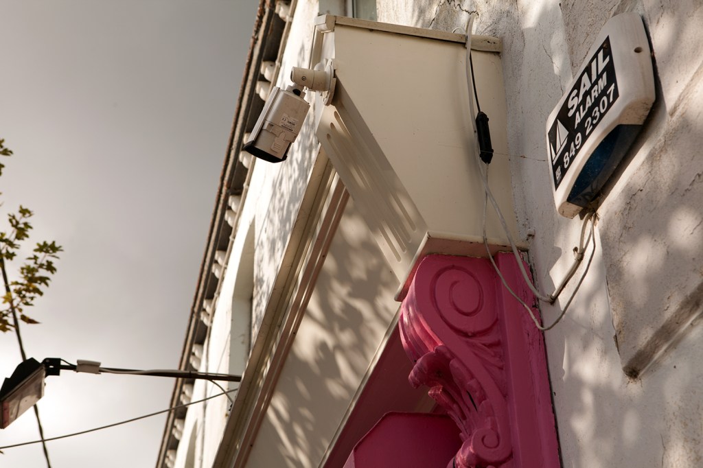 Pink carved wood - surveillance camera - white frame