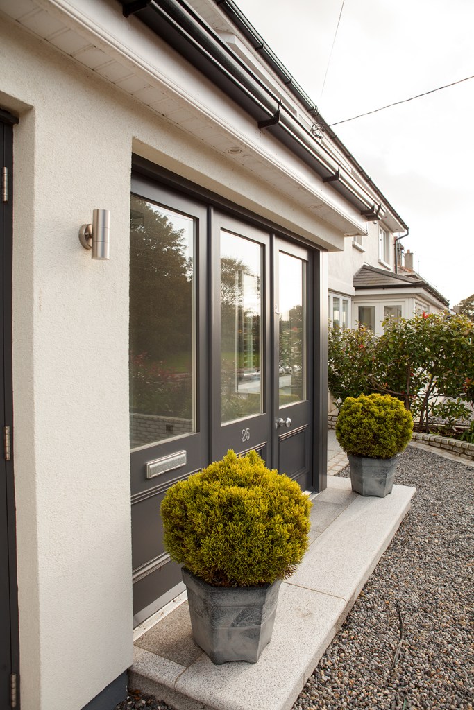 side view - door with glass window - pot plants - black door - front door