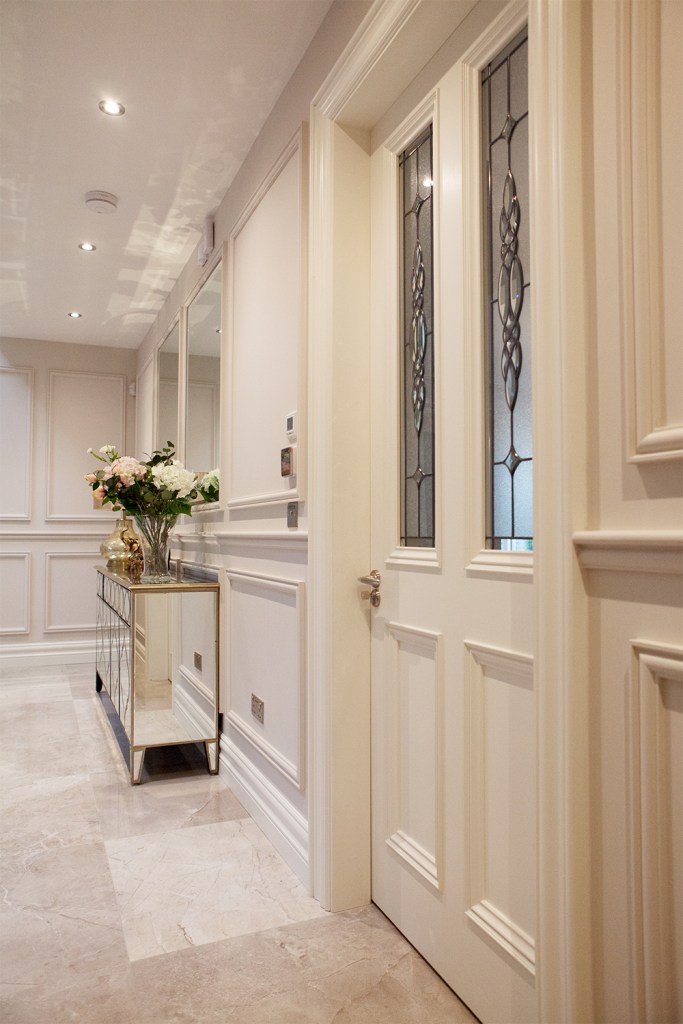 side view of transom door - white door and door frame - serving table with roses on