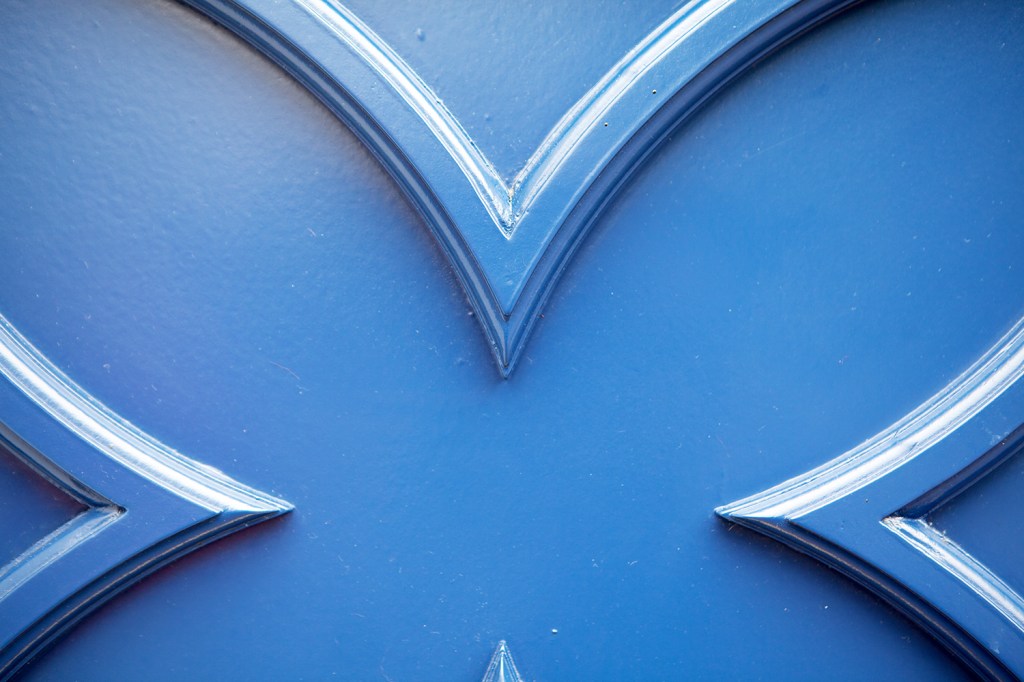 Carved wood painted blue on door